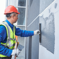 Fasádnictví, nanášení venkovní omítky – Dmitry Kalinovsky / Shutterstock